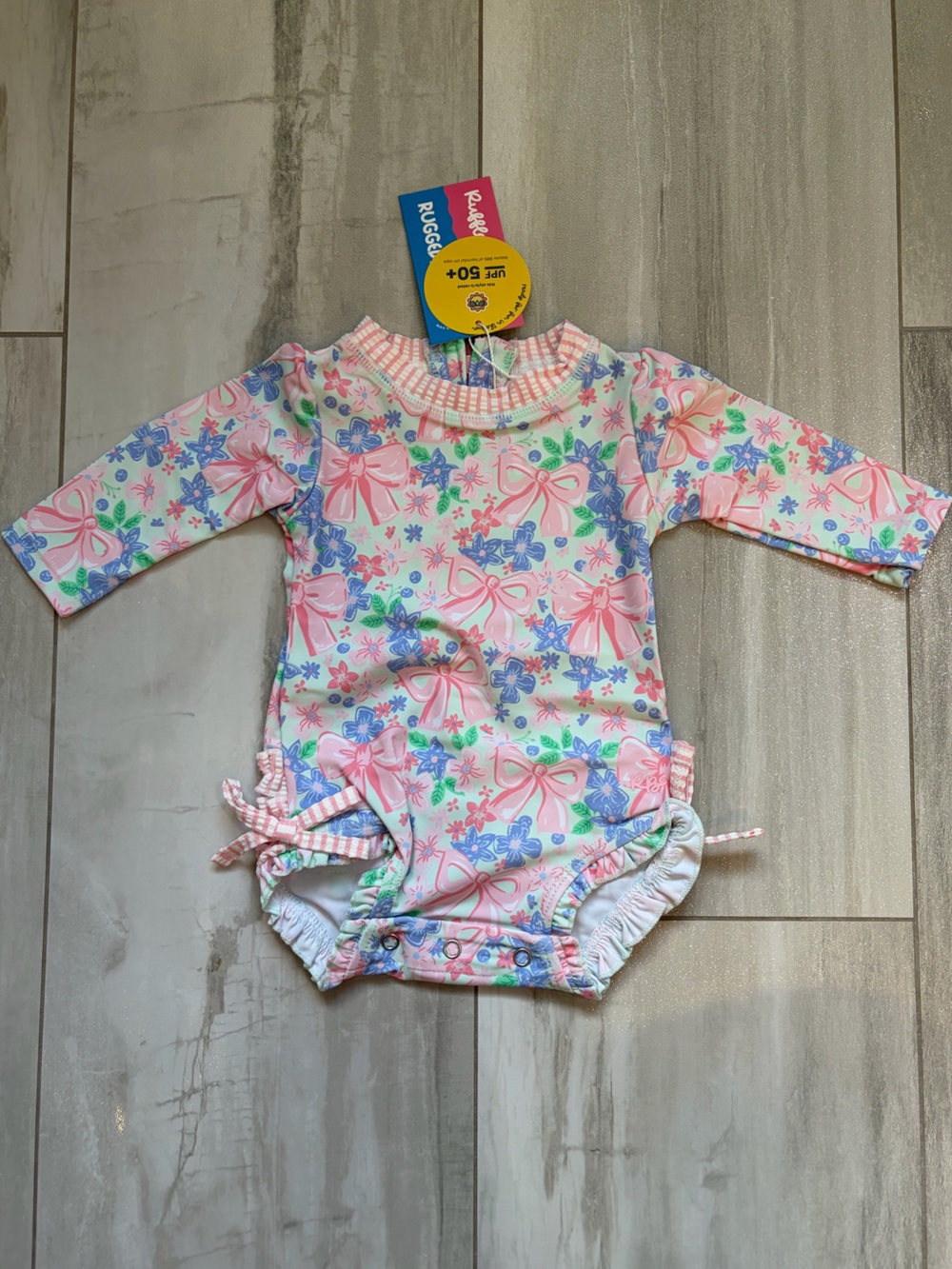 NWT RuffleButts Pastel Bow Blooms Long-Sleeve Rashguard Swimsuit Girls 3-6M
